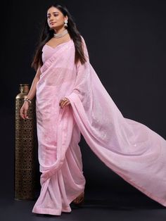 Look at this amazing Bollywood-style glowing baby pink georgette saree made with fully sequined work. This enchanting baby pink sequin saree comes with a matching georgette blouse also designed with fully sequined work. The saree is 5.50 meters long, while the blouse material is 0.80 meters.
Charming, rich, elegant, and flowy, this georgette saree is perfect for parties, engagements, or any special occasion. The baby pink color itself is sufficient to create a style statement, so you can go mini Pink Sequined Pre-draped Saree For Festivals, Pink Embellished Pre-draped Saree For Festivals, Embellished Pink Pre-draped Saree For Festivals, Pink Party Wear Pre-draped Saree With Mirror Work, Pink Party Wear Pre-draped Saree For Festivals, Pink Pre-draped Saree With Zari Work For Party, Pink Party Wear Pre-draped Saree In Georgette, Pink Embellished Pre-draped Saree For Diwali, Glamorous Pink Pre-draped Saree With Mirror Work