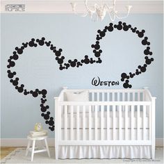 the mickey mouse wall decal is shown in this baby's room