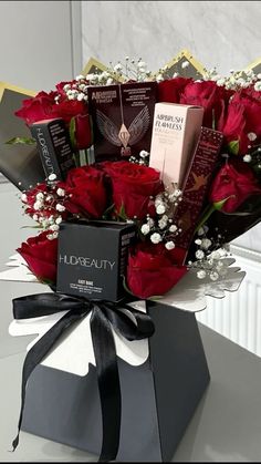 a bouquet of roses and chocolates in a gift box