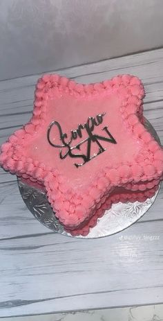 a pink cake with the word love on it