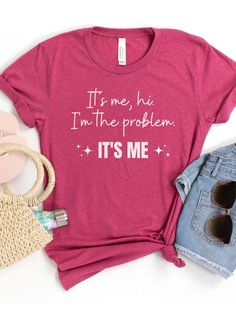 Introducing our "It's Me, Hi. I'm the Problem. It's Me" T-Shirt, a fun and playful shirt inspired by a popular song lyrics. Made from high-quality Bella + Canvas brand t-shirt, this shirt is both comfortable and durable. The design features the words "It's Me, Hi. I'm the Problem. It's Me" in a bold font, making it a great statement piece that will spark some conversations. Available in eight colors, including classic black and a variety of bright and bold hues, there's a shade for every style. Popular Song Lyrics, Bold Fonts, Silhouette Crafts, Music Lover, Jersey Shorts, Branded T Shirts, Women Collection, Song Lyrics, Classic Black