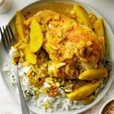 a white plate topped with rice and chicken