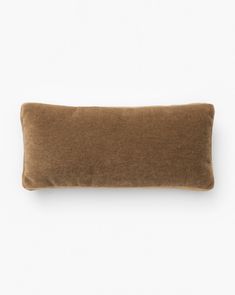 a brown pillow sitting on top of a white wall