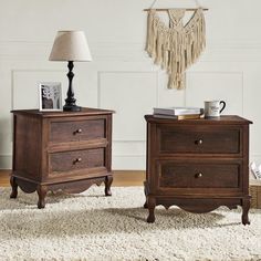 two wooden nightstands sitting next to each other on a white carpeted room floor