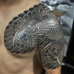 a man with a dragon tattoo on his chest