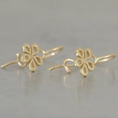 "Five gold leaves make a simple gold flower. These 14k gold earrings are a perfect Christmas gift to your wife and to your daughter. These dainty 14k gold earrings are small and gentle, all solid gold. You can wear these hanging flowers earrings with every kind of necklace: a gold necklace (with a flower pendant), colorful beads necklaces or a classic elegant pearl necklace. Which style would you love to wear these dangle gold earrings with?... Dimensions: * Diameter: 8 m\"m *Profile (width): 1 Gold Flower Charm Earrings In 14k Gold, 14k Gold Earrings With Flower Charm For Gift, 14k Gold Filled Flower Earrings As Gift, Gold Flower Earrings With Flower Charm, Gold Flower Earrings In 14k Gold, Gold Flower 14k Gold Pierced Earrings, Yellow Gold Earrings With Flower Charm For Gift, 14k Gold Flower Shaped Earrings For Gift, Yellow Gold Earrings With Flower Charm As Gift