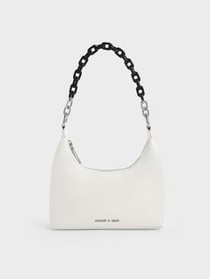 Our Koi chain handle shoulder bag strikes a balance between style and function. It features a striking white finish and two-tone chain handle that adds a touch of glamour to the minimalist design. Where functionality is concerned, a two-way zip closure lets you access your belongings easily, while a detachable shoulder strap offers a hands-free way to carry the bag. Accessorise an all-black ensemble with this classic design to create an eye-catching tonal contrast. Charles And Keith Bags, Black And White Bags, White Shoulder Bags, Expensive Bag, Tas Bahu, Luxury Bags Collection, Accessories Bags Shoes, Size Chart For Kids, Pretty Bags