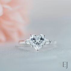 an engagement ring with a heart shaped diamond