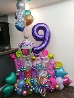 balloons and streamers are arranged in the shape of numbers