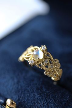 Sonia Moonstone Floral Gold Lace Filigree 18K Gold Vermeil Ring features moonstone in the centre, accented by lace filigree on the sides. It is similar to Monique Moonstone Ring in our shop, but the details of the ring are different. This is an adjustable ring, it comes in one size only and fits US ring size 5 to 8. ◊ 18K Gold Vermeil ◊ Adjustable Ring ◊ Sold in ONE SIZE only ◊ Fits US ring size 5 to 8 ◊ Lab Moonstone and cubic zircons ◊ Delivered in our signature royal blue box, it makes the pe Gold Moonstone Gemstone Ring For Anniversary, Heirloom Gold Moonstone Jewelry, Gold Moonstone Crystal Ring For Anniversary, Gold Moonstone Jewelry With Rose Cut Diamonds, Elegant 14k Gold Moon Shaped Ring, Gold Celestial Moonstone Ring With Rose Cut Diamonds, Gold Moonstone Open Ring For Anniversary, Gold Moonstone Ring With Rose Cut Diamonds For Gift, Gold Open Ring Moonstone For Anniversary