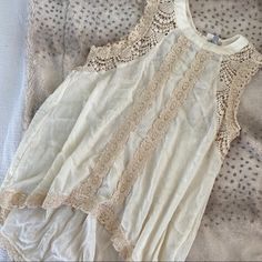 Dainty Lace Tank Top From Urban Outfitters. Never Worn And New With Tags. The Bottom Is Cut Higher In The Front, And Lower In The Back. Note: (2) Buttons Are Missing From The Back But Don’t Alter The Fit Of The Top! Sleeveless Beige Blouse With Lace Trim, Summer Beige Lace Work Tops, Beige Lace Tops For Summer, Beige Lace Work Summer Tops, Beige Lace Work Tops For Summer, Urban Outfitters Tops With Lace Trim For Spring, Chic Summer Tops With Lace Work, Cream Lace Patchwork Summer Blouse, Cream Lace Patchwork Blouse For Summer