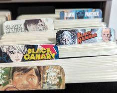 several black canary books are stacked on top of each other