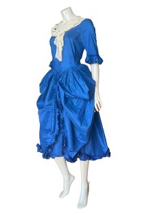 1920's blue silk fancy dress costume with side panniers 34" bust Here we have an authentic costume from the 1920's made out of royal blue silk.  Costume parties and events were very popular at the time and this beauty is very 18th century in style, or possibly a fairy tale princess, or Cinderella.  The dress has a fitted bodice and fastens centre front to the waist with press studs, the neckline is squared to the front.  Three quarter sleeves with fluted and frilled cuff. The skirts are densely gathered into the waist, which have huge side swags for the placement of the padded pouches giving the fullness effect of side panniers.  The centre front of the skirt is open, the sides sweep down are gathered into the same frill work as used on the cuffs. Two internal ties halfway down keep the ce Silk Costume, Authentic Costumes, Fairy Tale Princess, Fancy Dress Costume, Costume Parties, A Fairy Tale, Dress Costume, Fancy Dress Costumes, Blue Silk