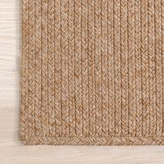 an area rug made out of jute on top of a wooden floor with a white background