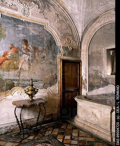 an ornately decorated room with paintings on the wall