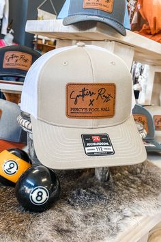 Your favorite hat with your favorite collab!These Richardson trucker hats are sure to keep you cool in the summer with a mesh back, and adjustable snapback for extra comfort! These feature our original Southern Roots X Percy's Pool Hall leather patch! 60% cotton/40% polyester adjustable plastic snapback richardson 112 Southern Roots Boutique112 W. Main St. Paragould, AR *Please allow 5-7 business days processing time for this item to be shipped/picked up. Adjustable Trucker Snapback Hat For Sports, Adjustable Trucker Hat For Sports, Summer Snapback Hat For Sports Events With Flat Brim, Summer Sports Snapback Hat With Flat Brim, Adjustable Trucker Baseball Cap For Baseball Season, Summer Sports Event Snapback Hat With Flat Bill, Baseball Season Trucker Hat With Flat Bill For Outdoor, Adjustable Snapback Trucker Hat For Baseball Season, Adjustable Trucker Hat With Flat Brim For Baseball Season