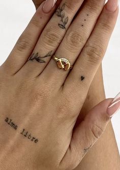 a woman's hand with tattoos on it