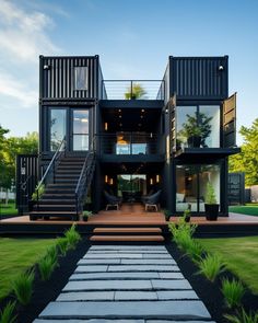 a large black house with stairs leading up to it