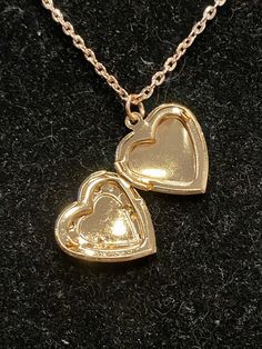 Necklace is rose gold in color Measures 18 inches in length Locket measures 1 inch in length and width Valentine's Day Rose Gold Metal Jewelry, Heart-shaped Rose Gold Charm Necklace, Rose Gold Metal Heart Necklace For Mother's Day, Rose Gold Heart Pendant Necklace With Clavicle Chain, Rose Gold Double Heart Clavicle Chain, Rose Gold Double Heart Necklace With Delicate Chain, Elegant Rose Gold Heart Necklace, Rose Gold Metal Heart Pendant Jewelry, Rose Gold Metal Heart Necklace