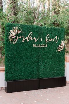 a green sign that says garden fun on it with flowers and greenery in the background