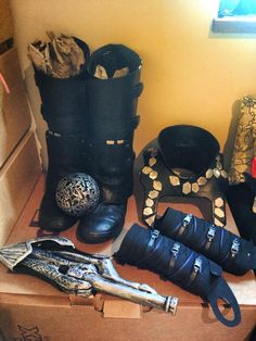 several pairs of boots and accessories are sitting on the floor