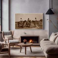 a living room filled with furniture and a fire place in front of a painting on the wall