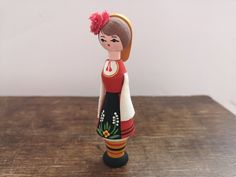 a figurine is standing on a wooden table