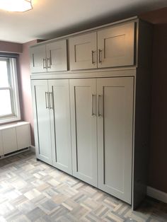 an empty room with white cabinets in it