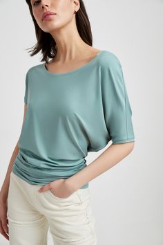 If you're in the mood to lounge luxuriously, Elena is the move. Fashioned from silky soft, eco-friendly European jersey, our all-day/all-night top features a loose scoop neck and asymmetric sleeves with a batwing on one side. Her oversized silhouette tapers below the waist for a flattering fit. Elena's versatile enough for professional or casual looks.[SPLIT] Julia, in slate green, is 5'10" (178 cm) tall, wearing size XS. Ariane, in off white, in light beige, and in dark blue, is 5’10.5” (179 cm Slate Green, Batwing Top, Night Tops, Scoop Neck Top, Oversized Silhouette, In The Mood, Off Shoulder Tops, Light Beige, Casual Tops