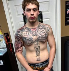 a man with tattoos on his chest standing in front of a door and looking at the camera