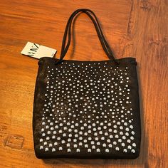 Zara Studded Tote Bag. Black With Silver Studs, Different Size Studs. Shoulder Straps. Magnetic Closure. Zipper Pocket On Interior. Size: 12” Height X 12” Length X 2” Width. Outer: 100% Polyurethane. Inner: 100% Polyester. New With Tag. Chic Silver Zara Shoulder Bag, Zara Silver Shoulder Bag For Evening, Silver Zara Shoulder Bag For Evening, Zara Silver Evening Shoulder Bag, Zara Silver Evening Bag, Chic Silver Zara Bags, Chic Shoulder Bag With Silver Accents For Everyday, Leather Evening Bags With Silver Accents, Evening Leather Bags With Silver Accents