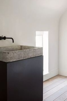 a bathroom sink sitting on top of a wooden floor