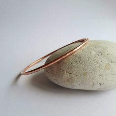 This simple, boho style, copper bangle is handmade from sturdy, pure copper wire which is hammered and textured so it twinkles and sparkles when it catches the light. These pretty bangles are made to order and sold either singly or as a set of 3 stacking bangles. Copper is the traditional gift for anyone celebrating their 7th anniversary. DETAILS AND MEASUREMENTS: * Handmade to order and ready to ship in 1 to 3 working days. * 100% pure copper. * Copper band is 2.6mm wide. * Flat rate shipping - Simple Boho Style, Stacking Bangles, 7th Wedding Anniversary, Copper Jewellery, 7th Anniversary Gifts, 7th Anniversary, Hammered Band, Handmade Bangles, Stacked Bangles