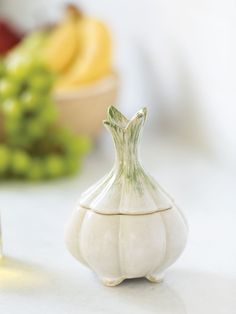 a small white vase sitting on top of a table