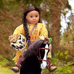 a doll sitting on top of a black horse