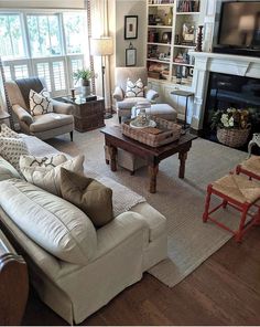 a living room filled with furniture and a flat screen tv mounted on a wall above a fire place