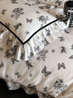 a black and white bed with butterflies on it