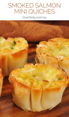 some food that is sitting on a wooden table with the words smoked salmon mini quiches