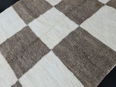 a brown and white checkered rug on top of a table