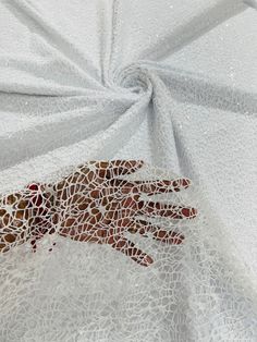 an image of a hand on white fabric