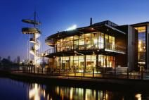 a large building sitting next to a body of water