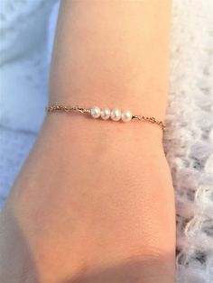 "Pearl and Gold Baby Bracelet/ 14 K Gold Filled Toddler Bracelet/ Little Girl Bracelet with Initial/ Baby Bracelet with Heart Charm Precious little bracelet is perfect for newborn gift, baptism/christening gift, 1st birthday gift, or just to show you care gift!! Stunning as flower girl bracelet too!! Really any occasion! Four delicate, 4 mm fresh water pearls adorn this golf filled bracelet. Gold Filled Chain is 2x2.3 mm, making this a sturdy chain that resists breaking from yanks or tugs of lit Elegant Adjustable Rosary Bracelet For Birthday, White Dainty Pearl Bracelet For Birthday, Dainty White Pearl Bracelet For Birthday, Elegant Adjustable Birthday Chain Bracelet, Elegant Adjustable Chain Bracelet For Birthday, Adjustable White Gold Hypoallergenic Bracelet, Dainty Adjustable Bracelet For Birthday, Dainty Beaded Bracelets For Birthday, Dainty Gold Bracelet For Birthday