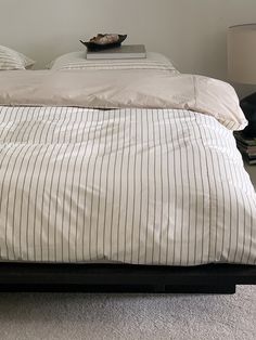 a bed with white and black striped sheets