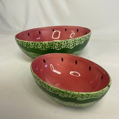 two watermelon shaped bowls with holes in them