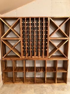 a wooden shelf with wine bottles in it