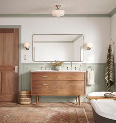 a bathroom with a tub, mirror and sink in it's centerpieces