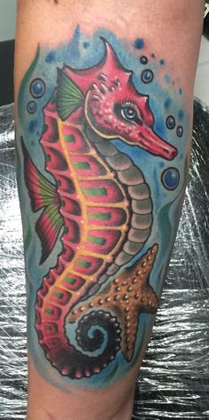 a colorful sea horse tattoo on the leg