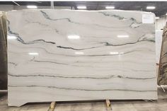 a large white marble slab is on display in a store with other items behind it