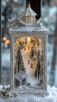 a small white box with a snow scene inside