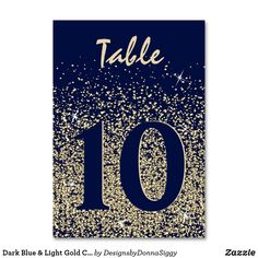 a black and gold table number sign with sparkles on it's edges, says table 10